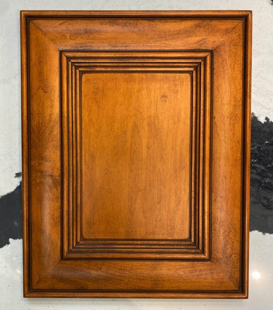 Victorian cabinet door with applied molding and arched raised panel, custom stained